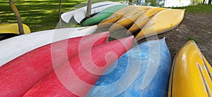 Canoes on the shore waiting for children in the summer camp