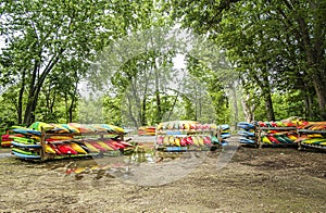 Canoes on wooden racks at the Berge des Baigneurs park in Laval