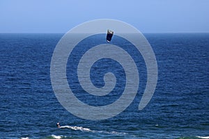 CANOPY OF KITE SURFER IN THE WIND OVER THE OCEAN