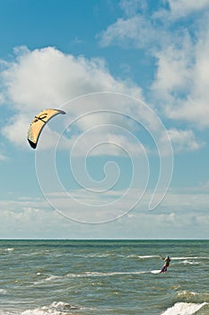 Canopy of a kiteboard and male teen at a tropical beach