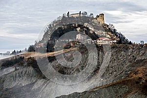 Canossa castle and countryside badlands in fog, Reggio Emilia, Italy photo