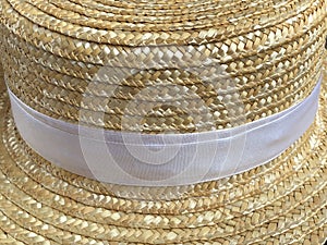 Canotier hat. Straw hat on wooden background