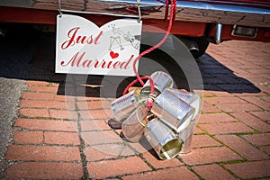 Cans attached to the back of a car to celebrate a wedd