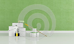 Cans and bucket with color paint and roller brush