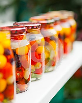 Cans with cherry tomatoes home canning on the table