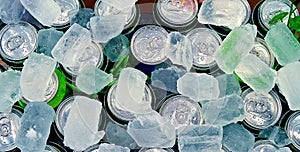 Cans of drink on ice cube