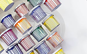 Cans with multicolored drips from a paint. Drops and spills on buckets of paint