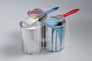 Cans of paints and brushes on light blue background