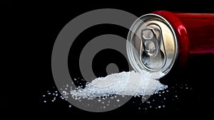 Cans of sugary drinks pour out separately on black background