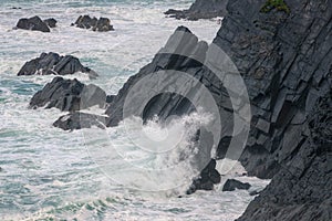 The Cantabrian Sea hits the black slate cliffs of Loiba photo