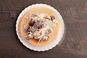 Cantaloupe with chicken grape salad on plate above view