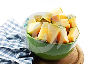 Cantaloupe melon slices on green bolw