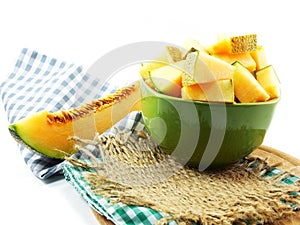 Cantaloupe melon slices on green bolw