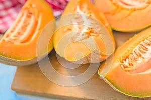 Cantaloupe melon slices on rustic wooden table