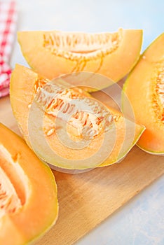 Cantaloupe melon slices on rustic wooden table