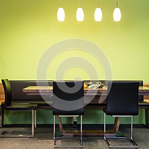 Cantilever chairs at timber table with lamps photo