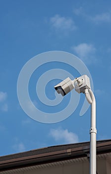 A cantilevered modern white security CCTV camera. photo