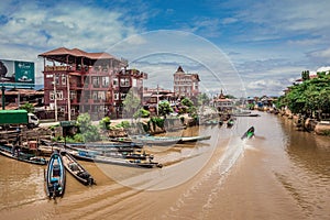 Inle Boat Station in Inle Nyaung Shwe Canal. A series of fishing boats along the river generated by Inle Lake