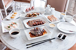 Cantonese meal including BBQ Pork, Roasted Duck, Fresh Shrimp Spring Rolls, Deep fried snapper fillets with XO Sauce and sweets.