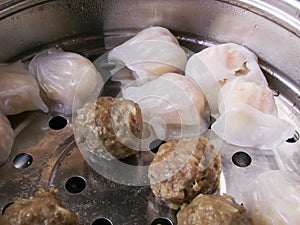 Cantonese starters har kau dumplings in steamer cooking