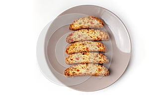 Cantucci cookies with candied fruit on brown plate