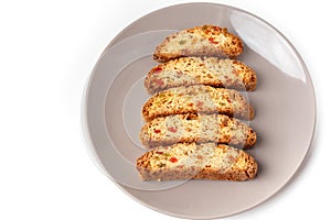 Cantucci cookies with candied fruit on brown plate