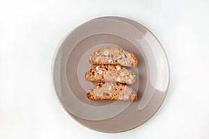 Cantucci cookies with nuts on brown plate