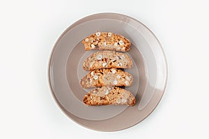 Cantucci cookies with nuts on brown plate