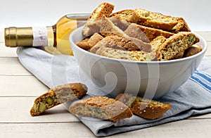 Cantucci d\'Abruzzo with pistachios and citron on wooden table.