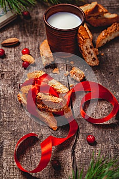 Cantucci with milk on wooden rustic table. Close up
