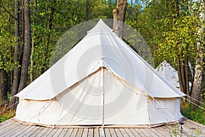 Canvas glamping tent at forest