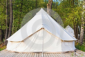 Canvas glamping tent at forest photo