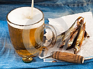 Canvas, glass of beer, salty fish