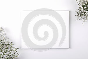Canvas mockup with smal white flowers on a white background