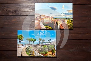 Canvas photo prints on brown wooden background. Front view of colorful photographs printed on glossy synthetic canvas. Photos