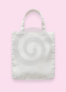 Canvas tote bag mockup blank white eco shopping sack template made of fabric cloth isolated on pastel pink background