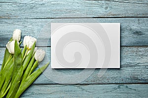 Canvas and white flowers on old light blue wooden background