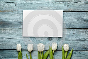 Canvas and white flowers on old light blue wooden background