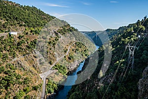 Canyon with rocks and vegetation and river ZÃÂªzere, aerial view on Cabril dam with bridge, PedrogÃÂ£o Grande PORTUGAL photo