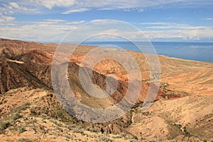 The canyon Skazka (Fairy Tale) and Issyk Kul lake on the background, Kyrgyzstan