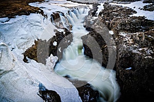 Canyon Waterfall in Iceland during winter with melting snow