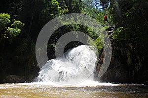 Canyoning male jumping into canyon Vietnam