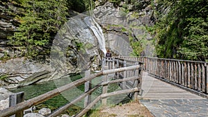 Canyoning waterfall view from a wooden bridge trees on both sides, Maltatal, Austria