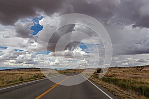 Canyonland - Long empty highway travels through desert of American Southwest near near Moab, Utah, USA