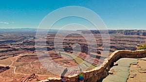 CANYONLAND, UT - JUNE 2018: Two girls enjoy the beautiful canyon scenario