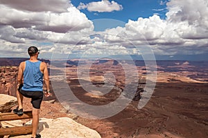 Canyonlands - Man with scenic view on Colorado River canyon seen from Buck Canyon Overlook near Moab near Moab, Utah, USA