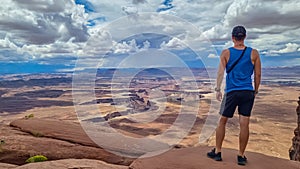 Canyonlands - Man with scenic view of Split Mountain Canyon seen from Green River Overlook, Moab, Utah, USA