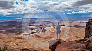 Canyonlands - Man with scenic view of Split Mountain Canyon seen from Green River Overlook, Moab, Utah, USA