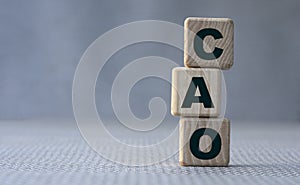 CAO word concept on wooden cubes on gray background