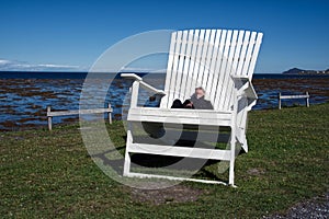 Big chair, little man at Cap-Chat photo